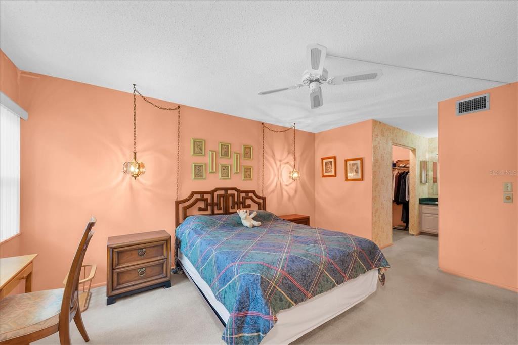 12300 Vonn Road, Unit 4101 Largo, FL 33774 - Photo 22 of 46 a bedroom with a bed and a chandelier