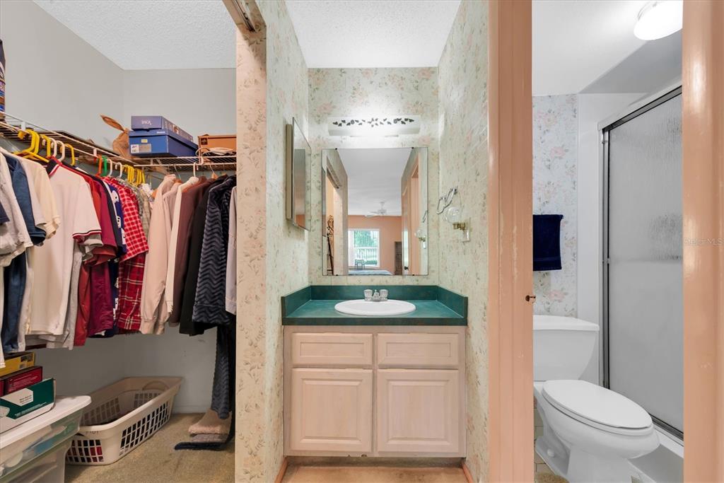 12300 Vonn Road, Unit 4101 Largo, FL 33774 - Photo 23 of 46 a bathroom with a granite countertop sink a toilet and a shower