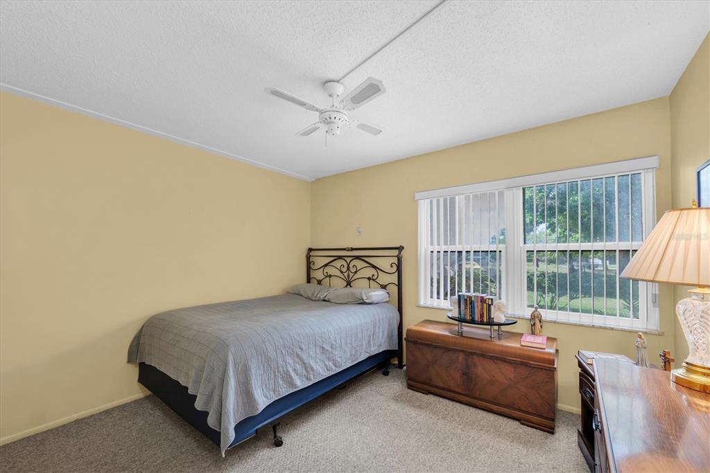 12300 Vonn Road, Unit 4101 Largo, FL 33774 - Photo 28 of 46 a bedroom with a bed and a couch