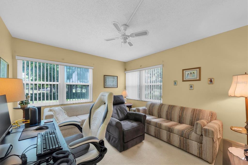 12300 Vonn Road, Unit 4101 Largo, FL 33774 - Photo 30 of 46 a living room with furniture a ceiling fan and a window