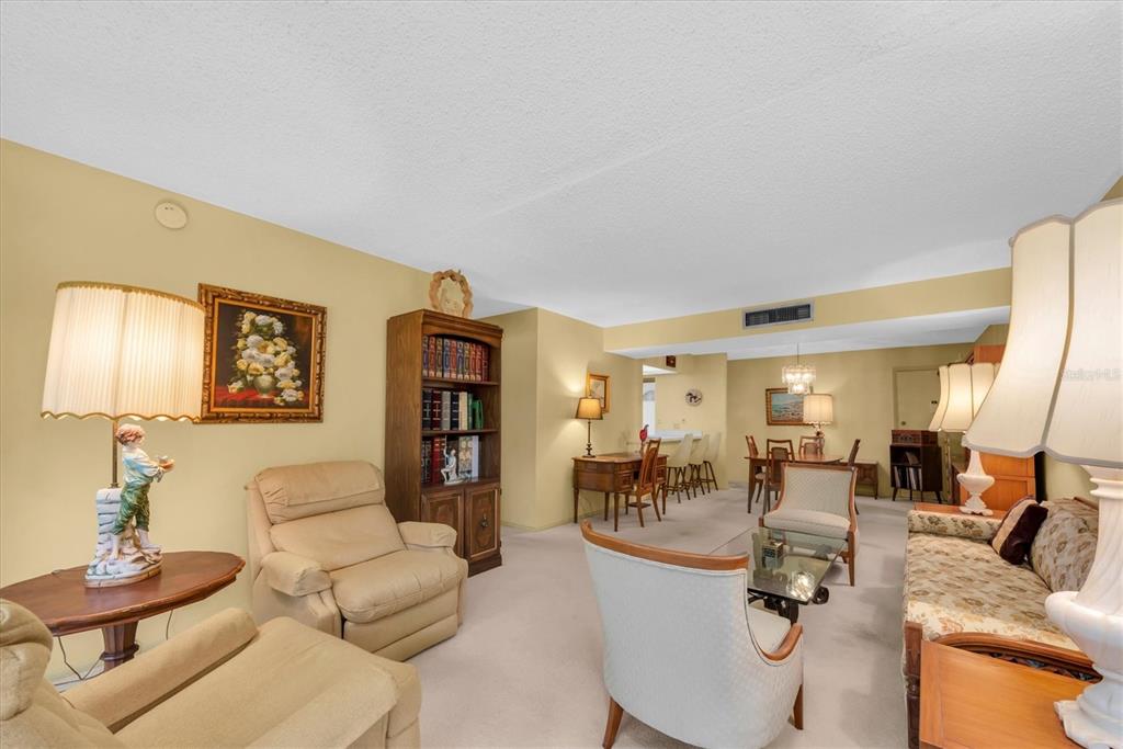 12300 Vonn Road, Unit 4101 Largo, FL 33774 - Photo 6 of 46 a living room with furniture and a dining table
