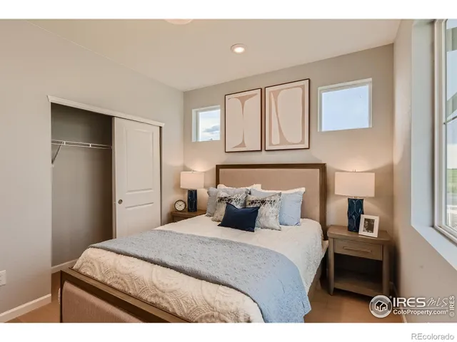 a bedroom with a bed and a night stand