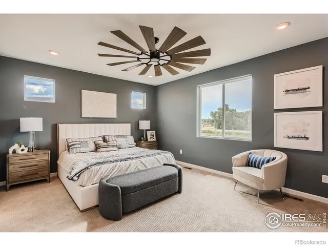 a bedroom with a bed couch and window