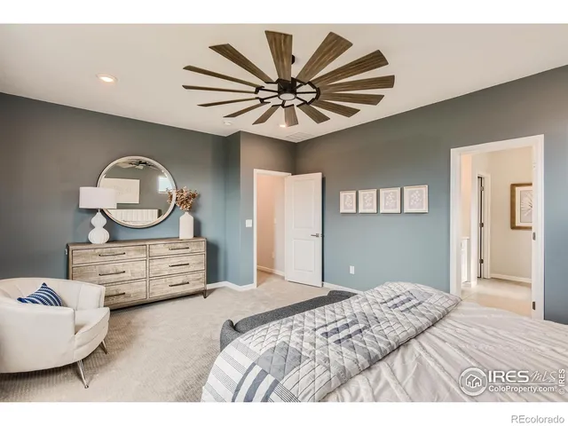 a bedroom with a bed chandelier and a window