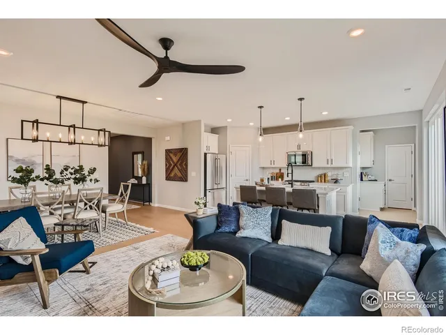 a living room with furniture and kitchen view