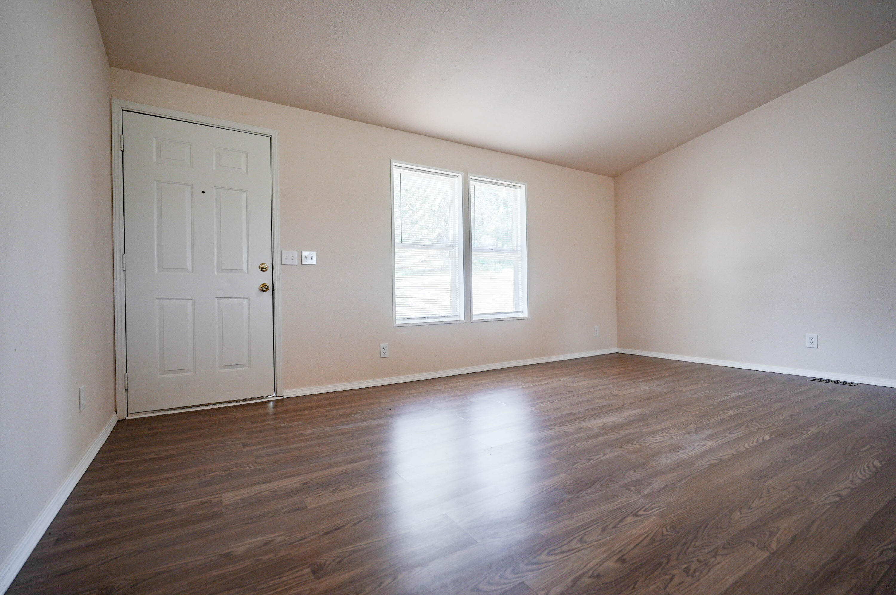 25016 Drews Road Chiloquin, OR 97624 - Photo 11 of 54 an empty room with wooden floor and windows