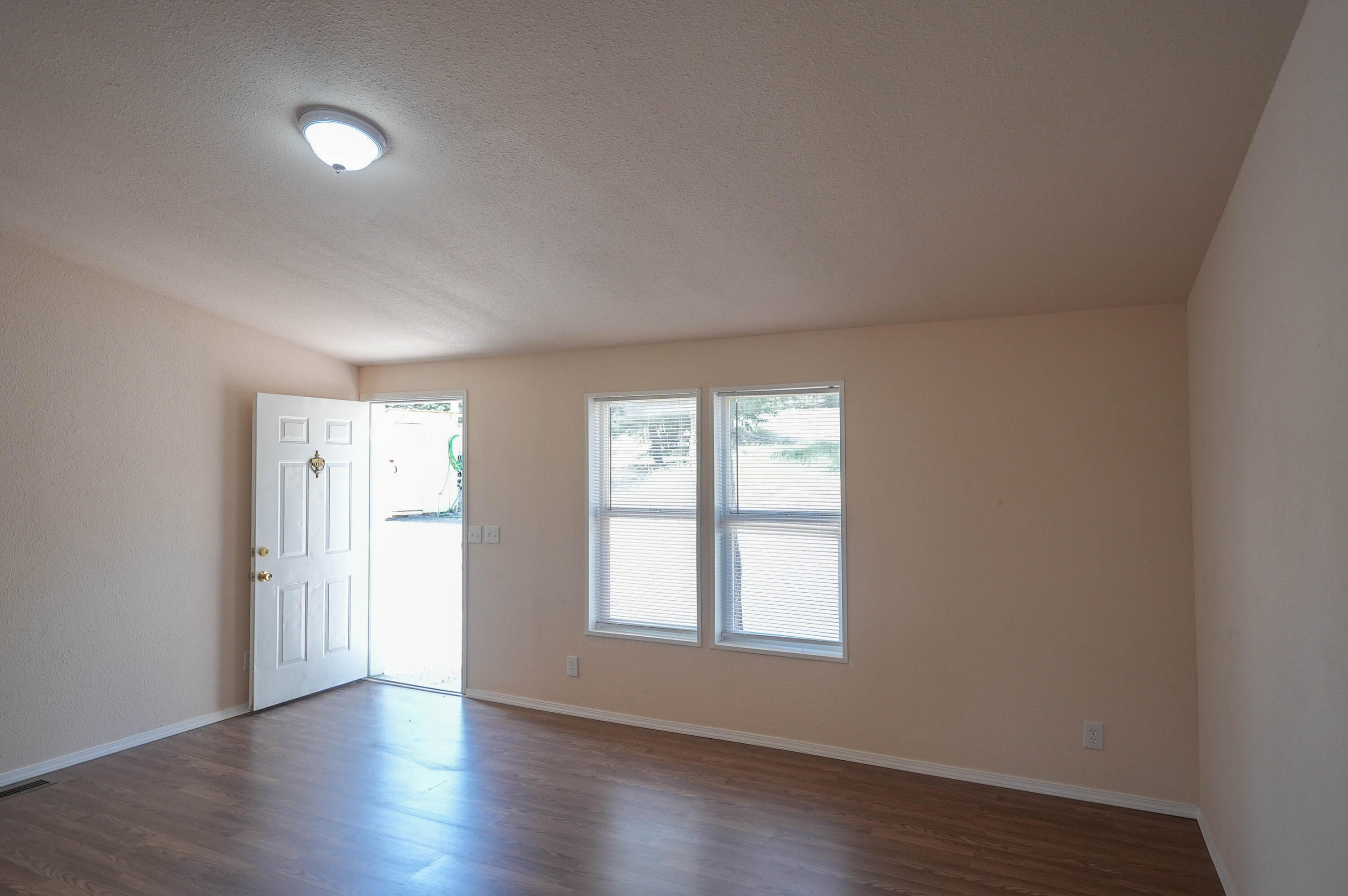 25016 Drews Road Chiloquin, OR 97624 - Photo 15 of 54 an empty room with wooden floor and windows