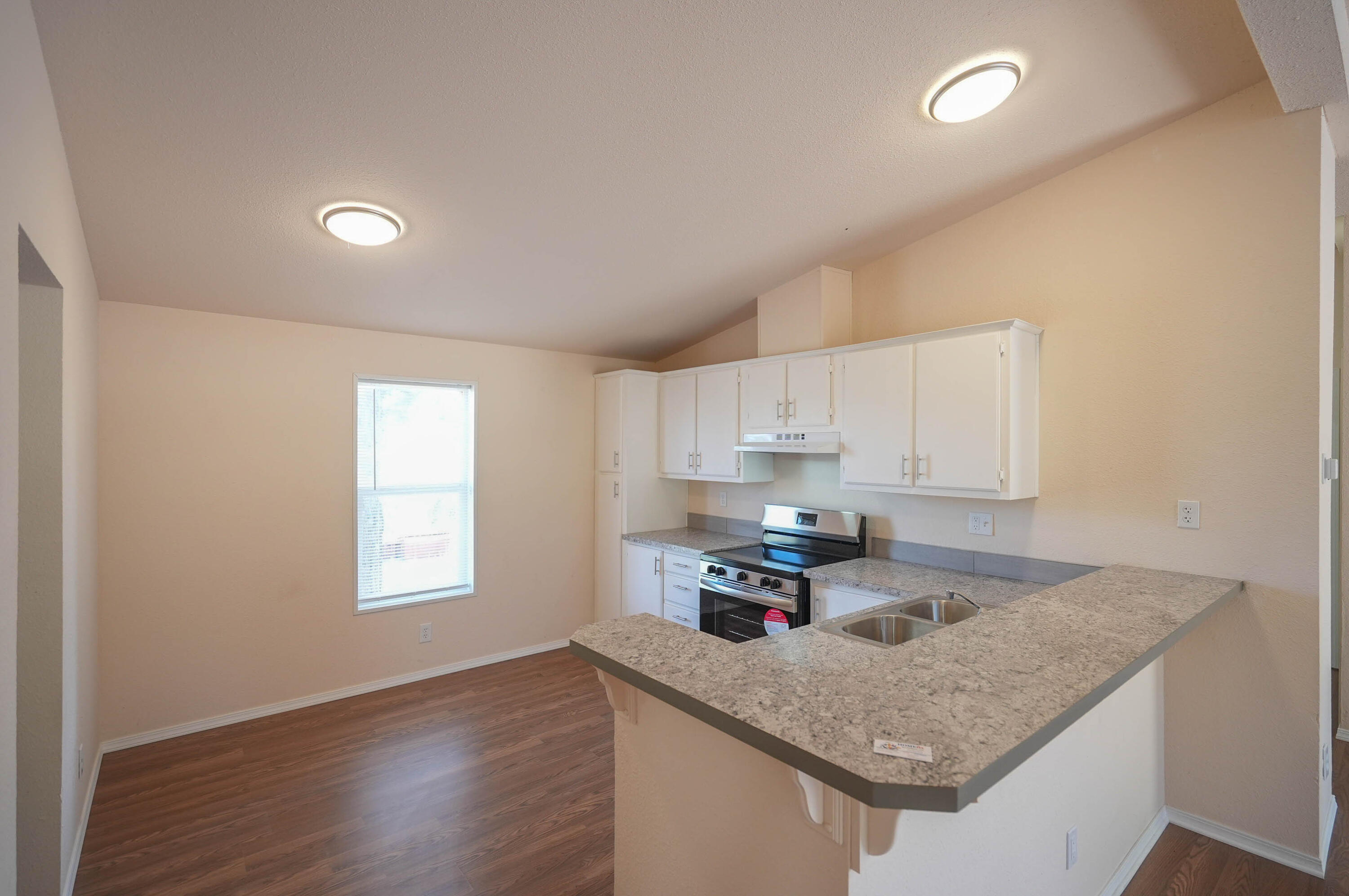 25016 Drews Road Chiloquin, OR 97624 - Photo 16 of 54 a kitchen with stainless steel appliances granite countertop a sink dishwasher a stove a refrigerator with white cabinets and wooden floor