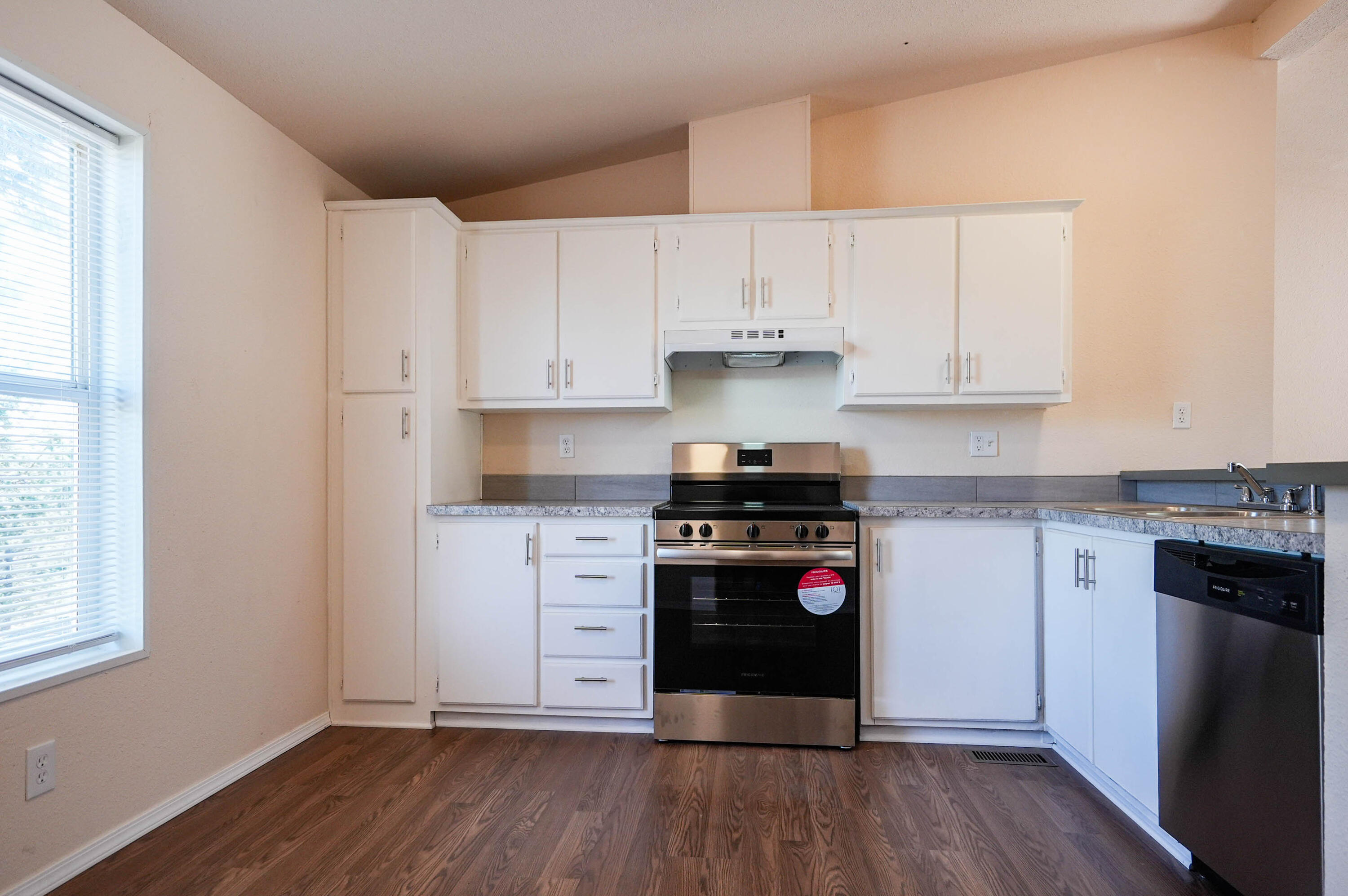 25016 Drews Road Chiloquin, OR 97624 - Photo 17 of 54 a kitchen with stainless steel appliances granite countertop a stove and white cabinets