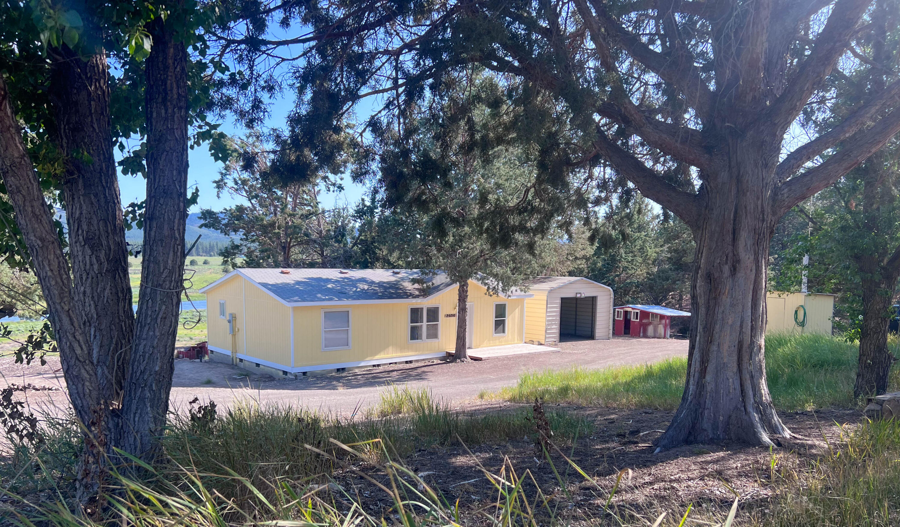 25016 Drews Road Chiloquin, OR 97624 - Photo 2 of 54 a view of a house with backyard and trees