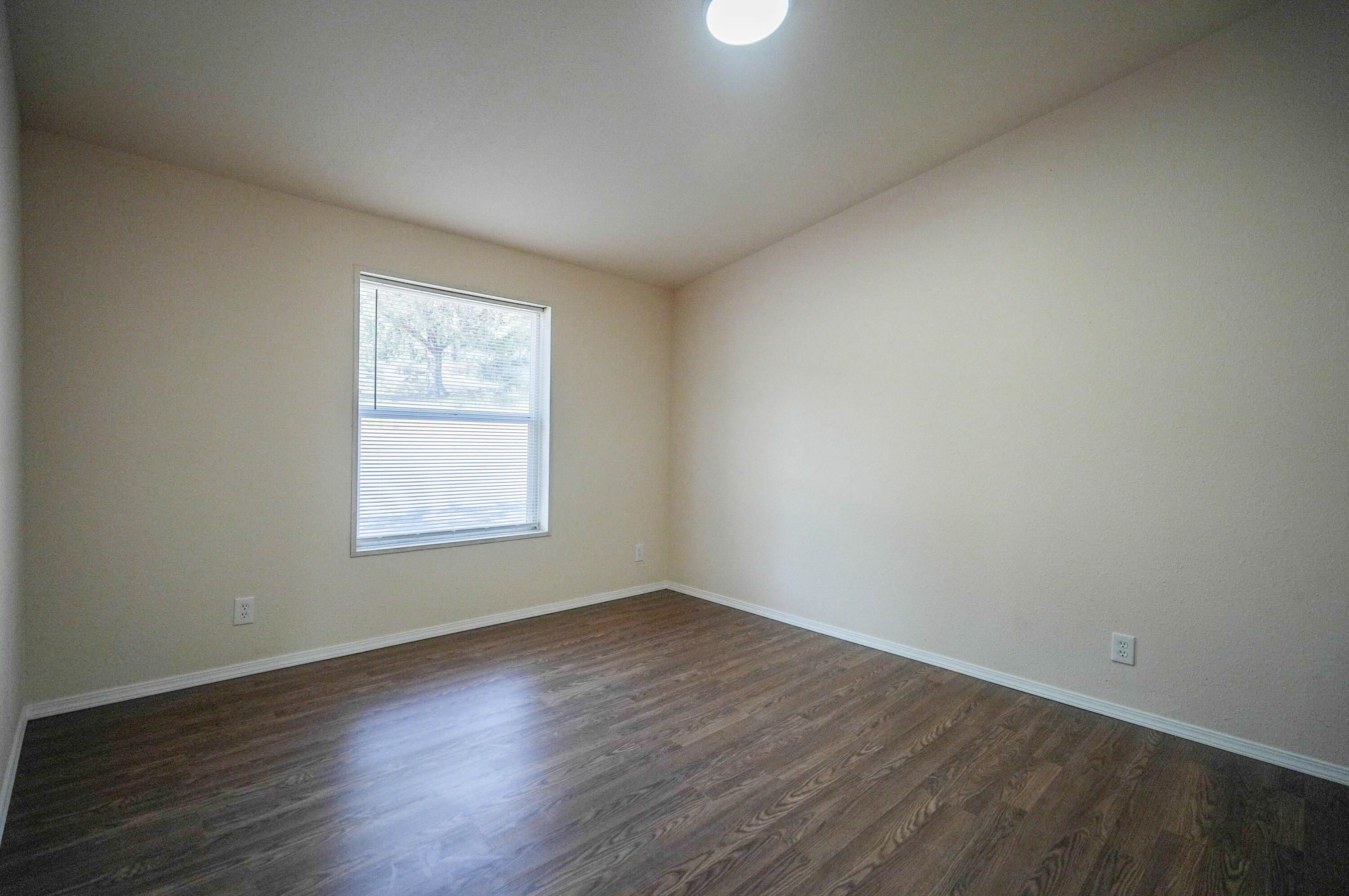 25016 Drews Road Chiloquin, OR 97624 - Photo 22 of 54 an empty room with wooden floor and windows