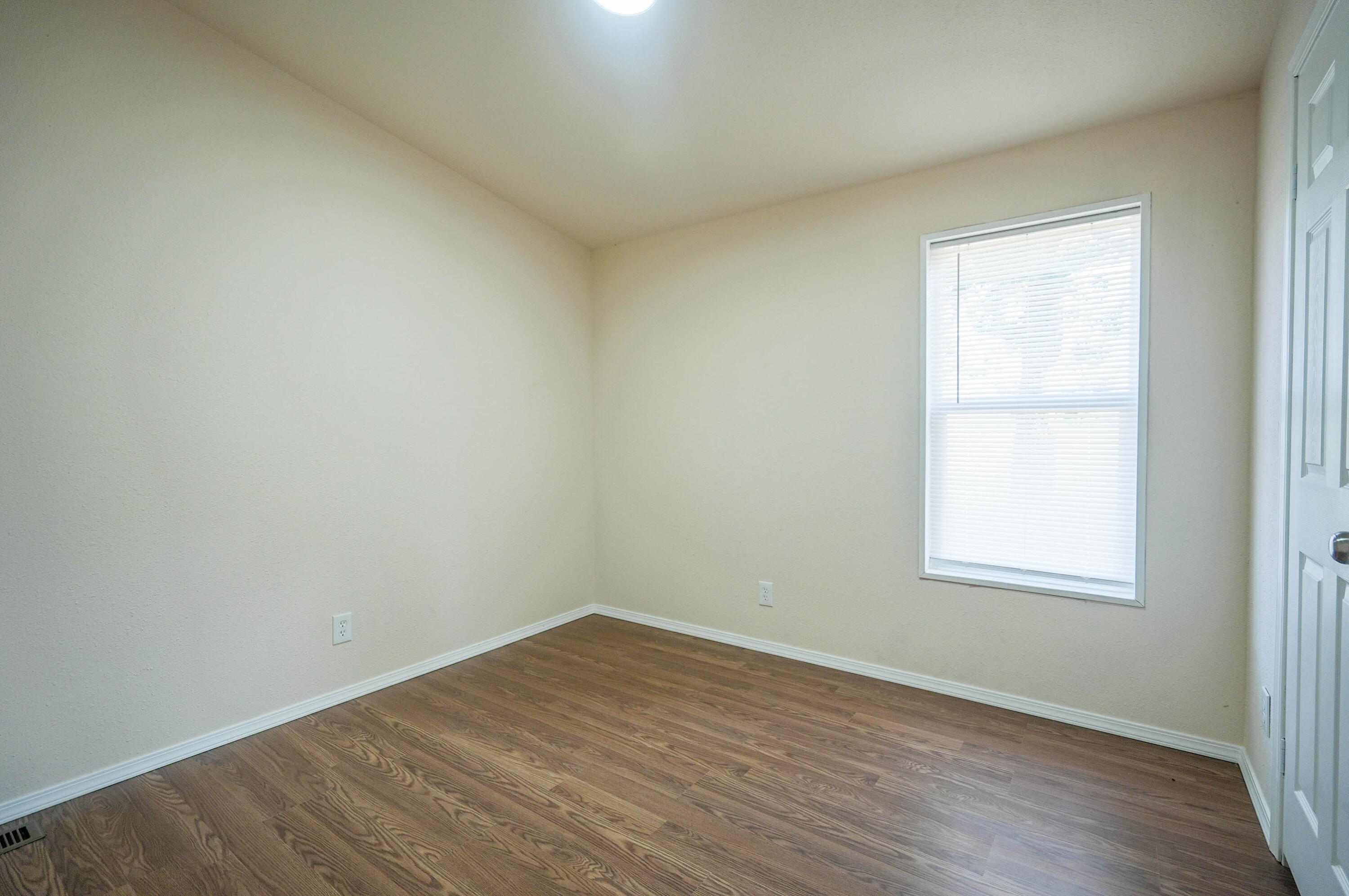 25016 Drews Road Chiloquin, OR 97624 - Photo 29 of 54 an empty room with wooden floor and windows