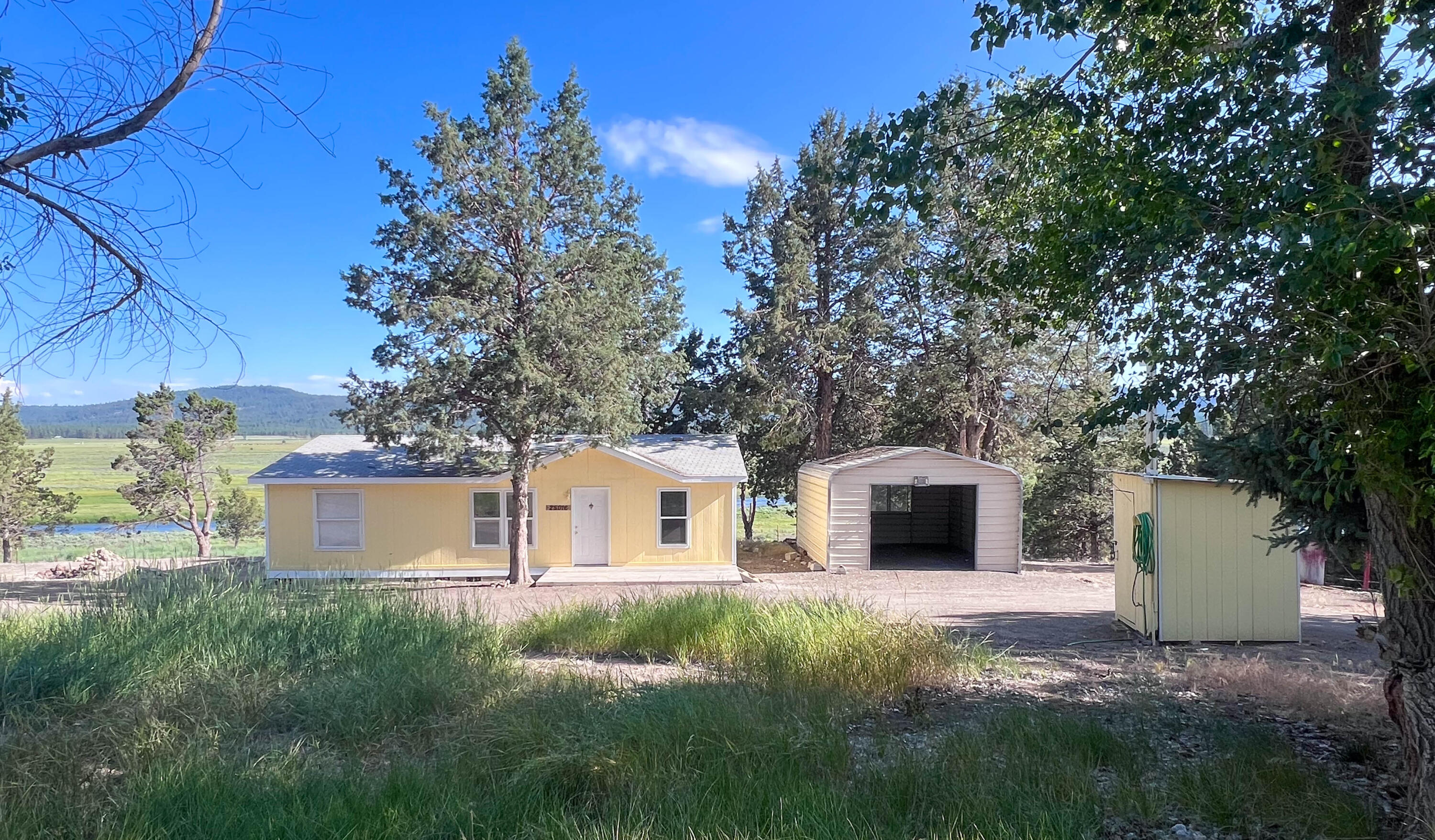 25016 Drews Road Chiloquin, OR 97624 - Photo 3 of 54 a front view of a house with garden