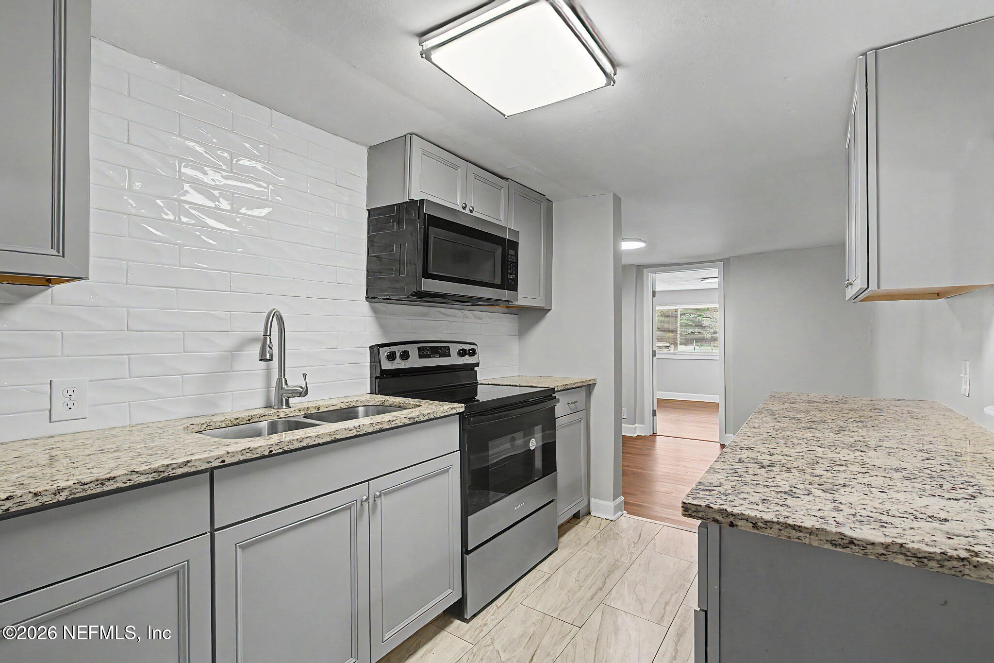 2625 Kohn Road Jacksonville, FL 32210 - Photo 33 of 34 a kitchen with granite countertop kitchen island cabinets stainless steel appliances and a sink