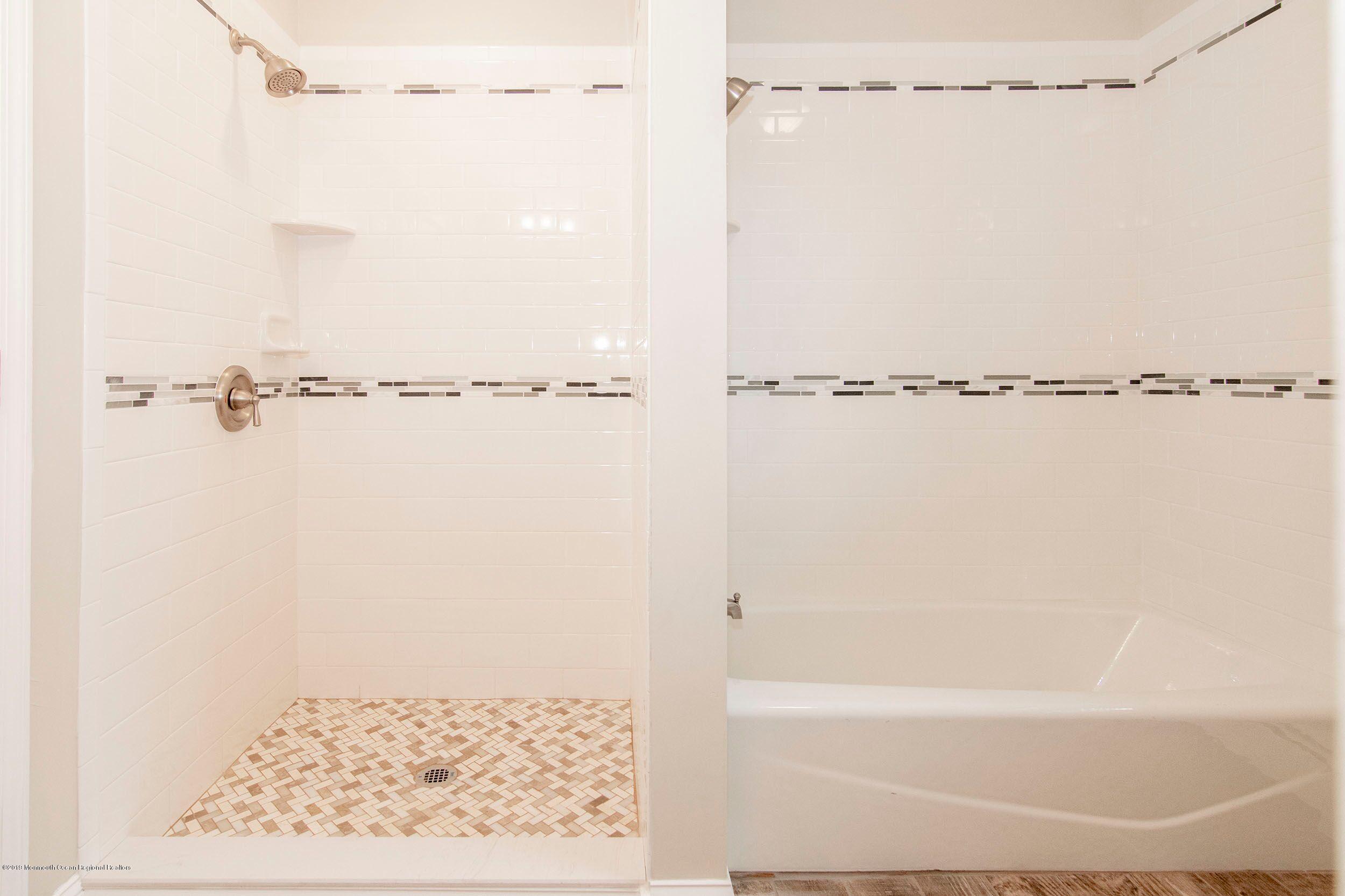 654 Thoroughfare Road Brick, NJ 08724 - Photo 8 of 17 a bathroom with a shower and a bath tub