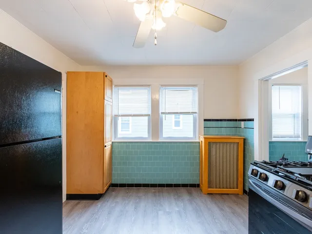 a kitchen with a stove and a refrigerator