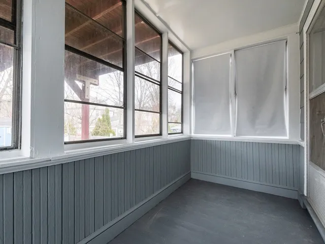 a living room with furniture a rug and a book shelf