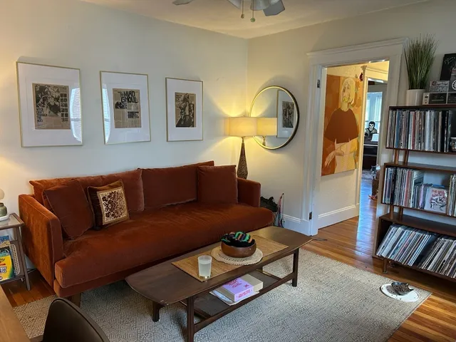 a view of a workspace with furniture and a potted plant
