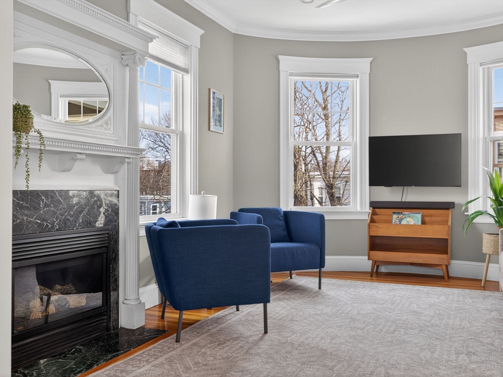 71 Parkton Road, Unit 2 Boston, MA 02130 - Photo 4 of 26 a living room with furniture and a fireplace