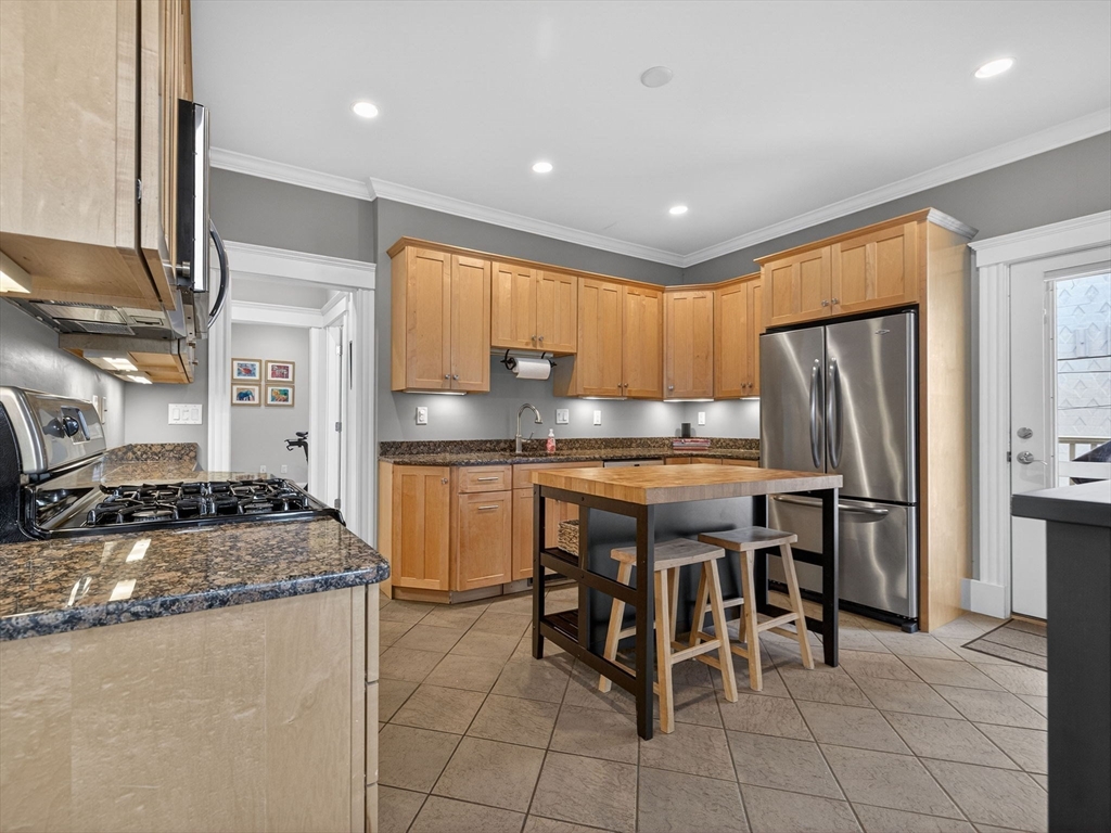 71 Parkton Road, Unit 2 Boston, MA 02130 - Photo 8 of 26 a kitchen with granite countertop cabinets and refrigerator