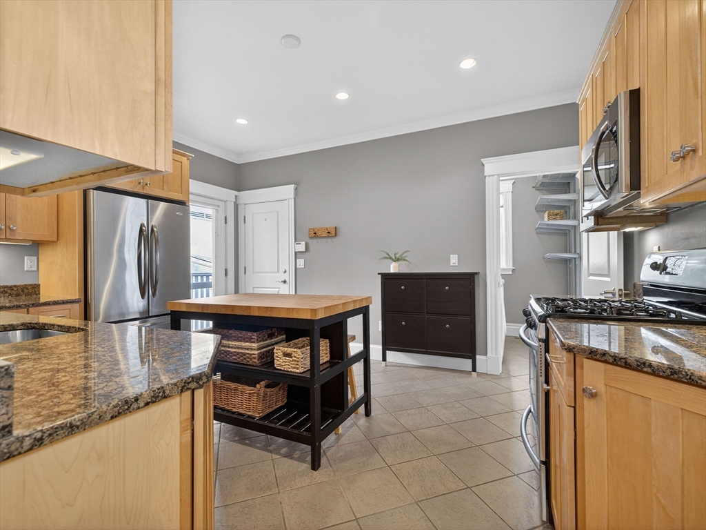 71 Parkton Road, Unit 2 Boston, MA 02130 - Photo 10 of 26 a kitchen with stainless steel appliances granite countertop a stove a sink and a refrigerator