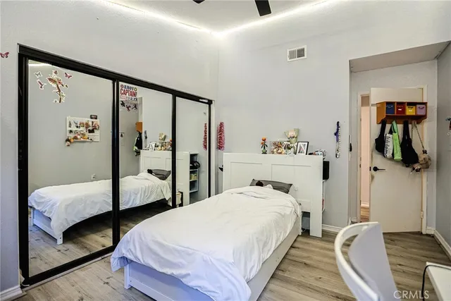 a bedroom with a bed and wooden floor