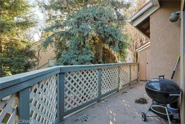 a balcony with table and chairs