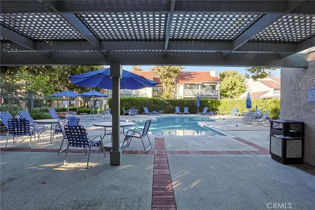 a patio with a table chairs and a barbeque