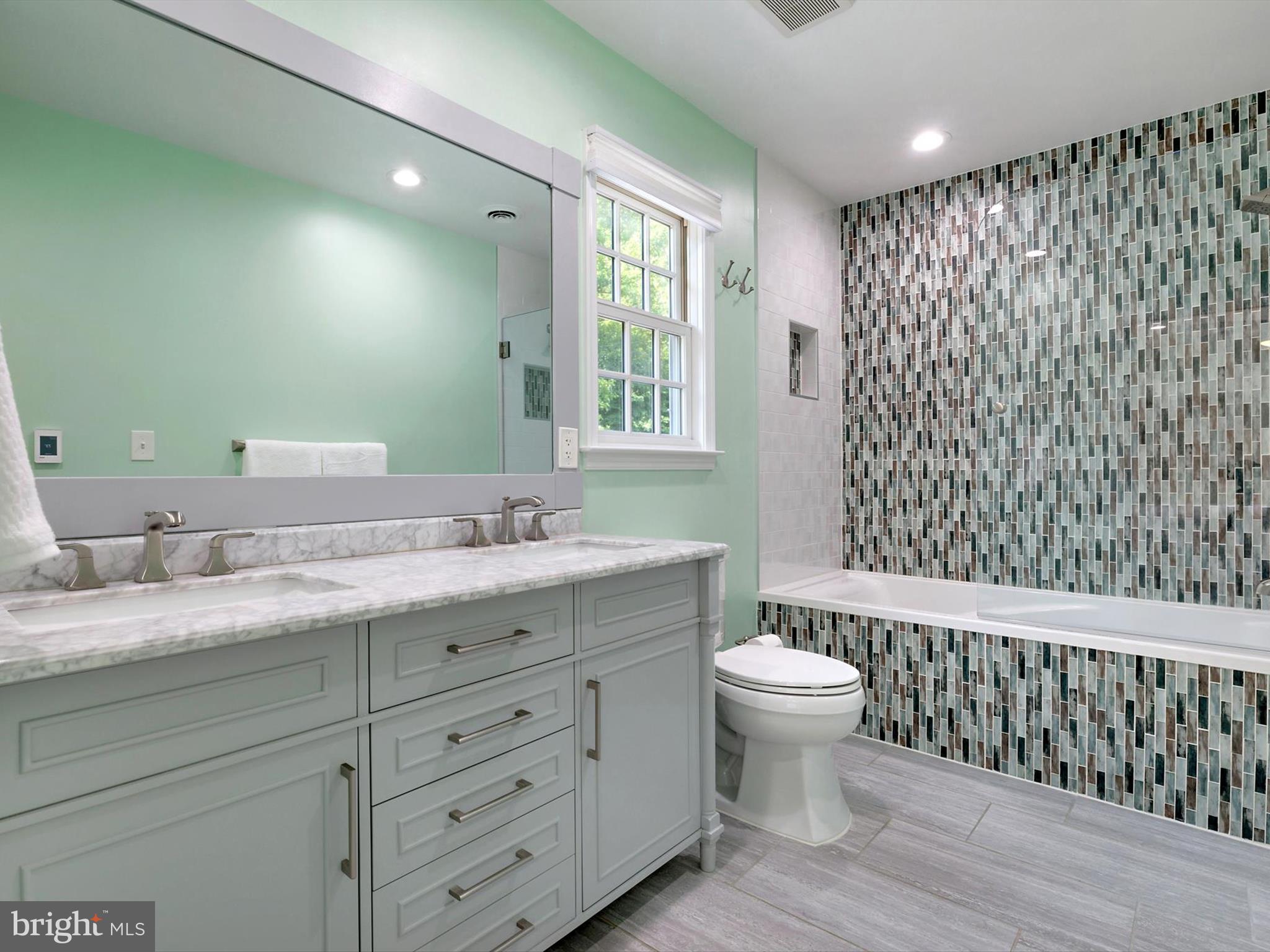 6 Brice Road Annapolis, MD 21409 - Photo 25 of 107 a bathroom with a granite countertop toilet a sink a mirror a window and a shower