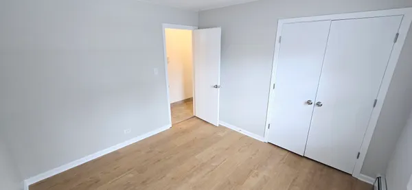 a view of an empty room with closet