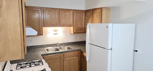 a kitchen with a refrigerator and a stove