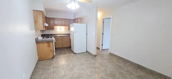 a view of a kitchen with a sink and a refrigerator