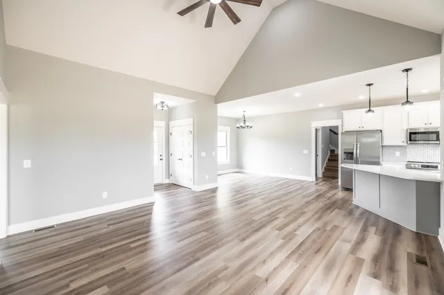 a view of a house with wooden floor and a kitchen