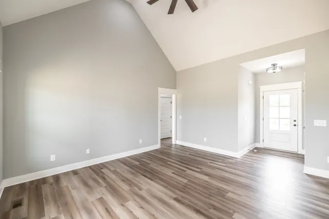 a view of a kitchen with a refrigerator and a stove top oven