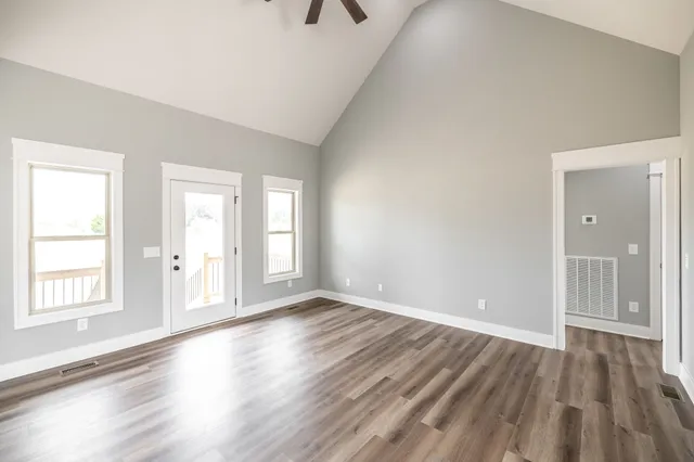 a kitchen with stainless steel appliances a sink a stove a refrigerator cabinets and a window