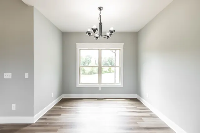 a kitchen with a sink a window and cabinets
