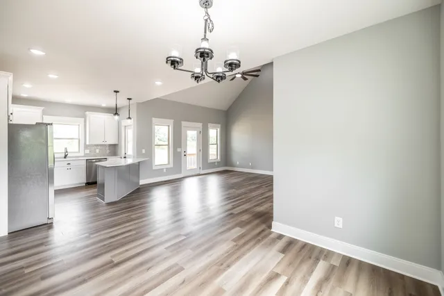 a kitchen with stainless steel appliances granite countertop a stove a refrigerator and a microwave