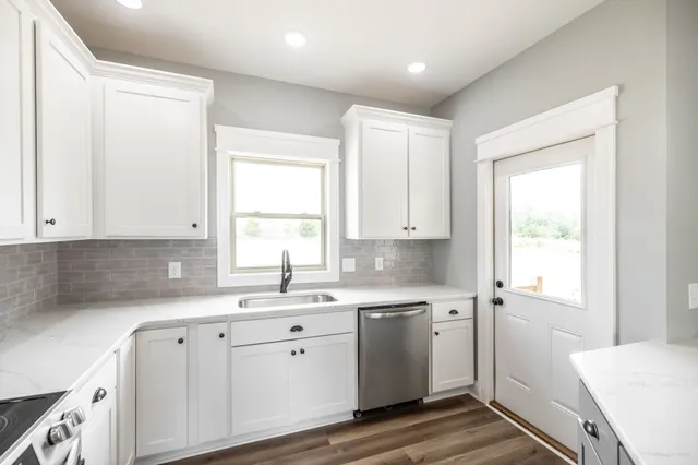 a view of a livingroom with wooden floor and a ceiling fan