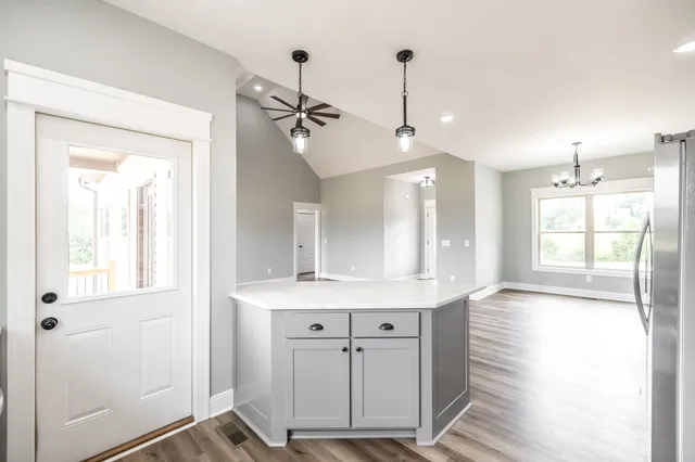a view of a room with wooden floor