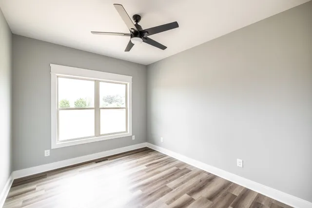 a living room with furniture a ceiling fan and a rug