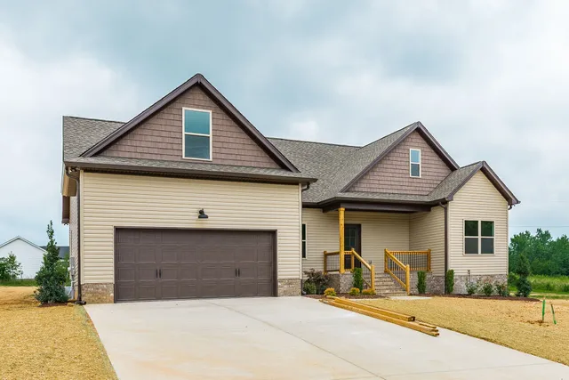 a front view of a house with yard and glass windows