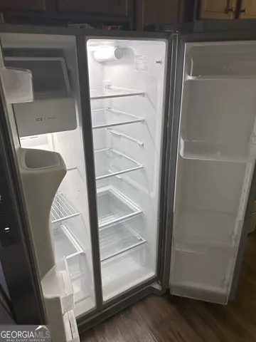 a kitchen with granite countertop cabinets and a stove top oven
