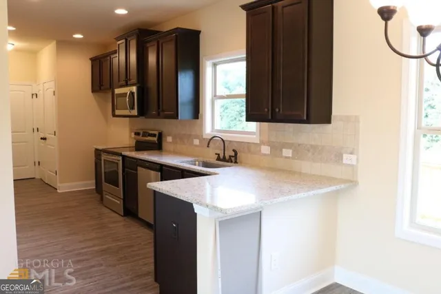 a kitchen with a sink and a refrigerator