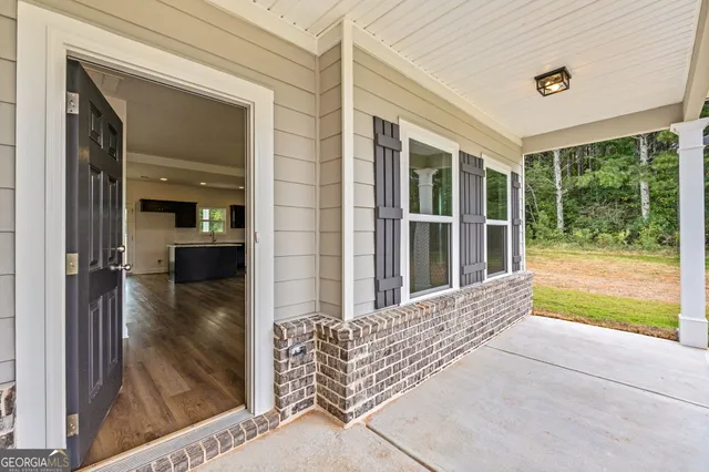 a large kitchen with stainless steel appliances granite countertop a refrigerator a sink dishwasher a stove and a wooden floors