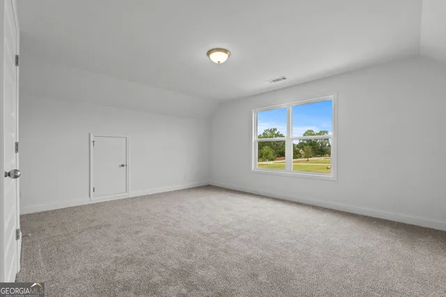 a bedroom with bed tv and window