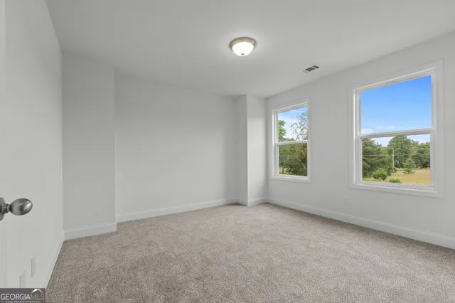 a picture of door with an open kitchen view