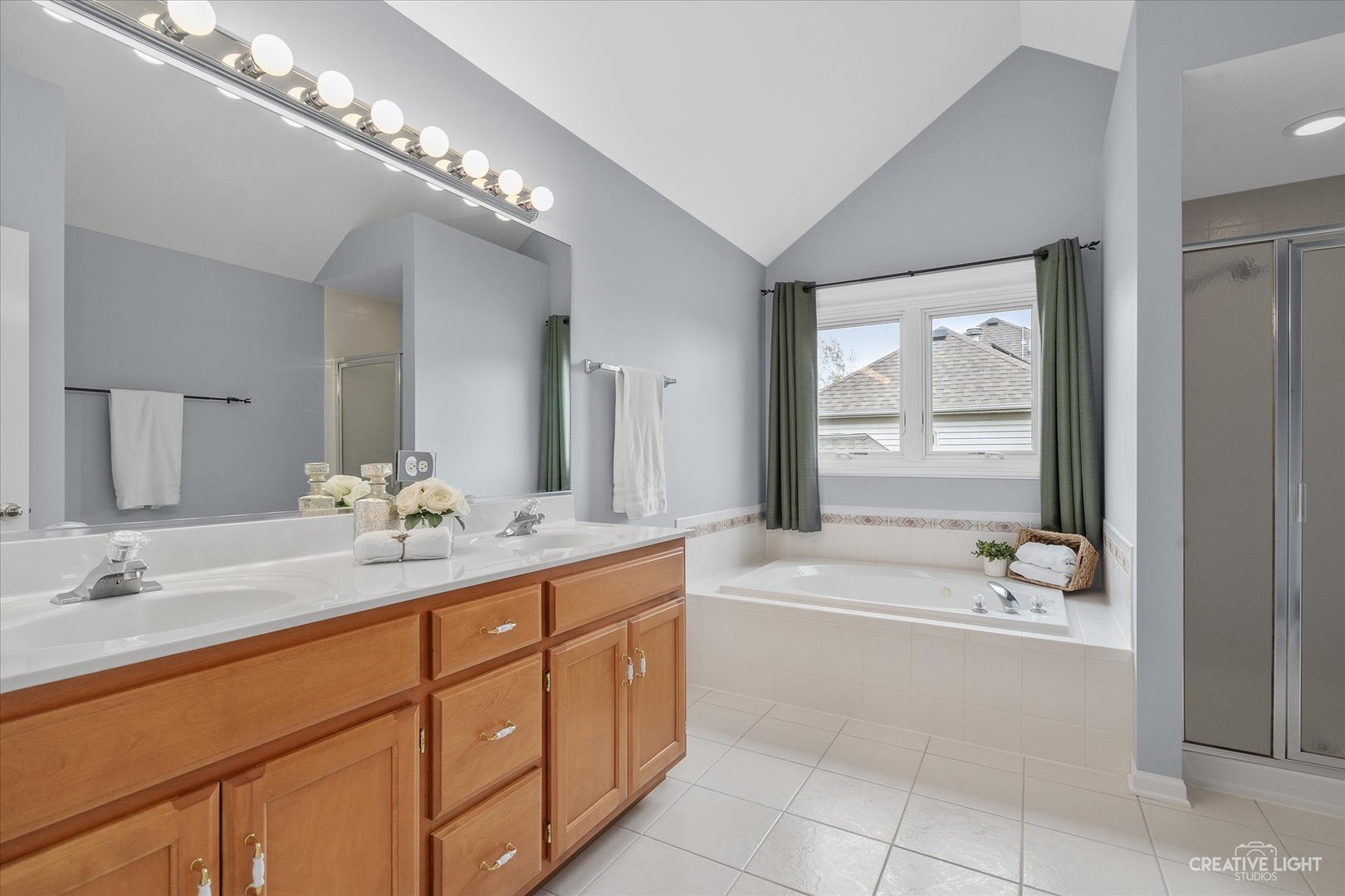 3812 Grassmere Road Naperville, IL 60564 - Photo 20 of 46 a spacious bathroom with a granite countertop tub a double vanity sink a vanity and a large mirror