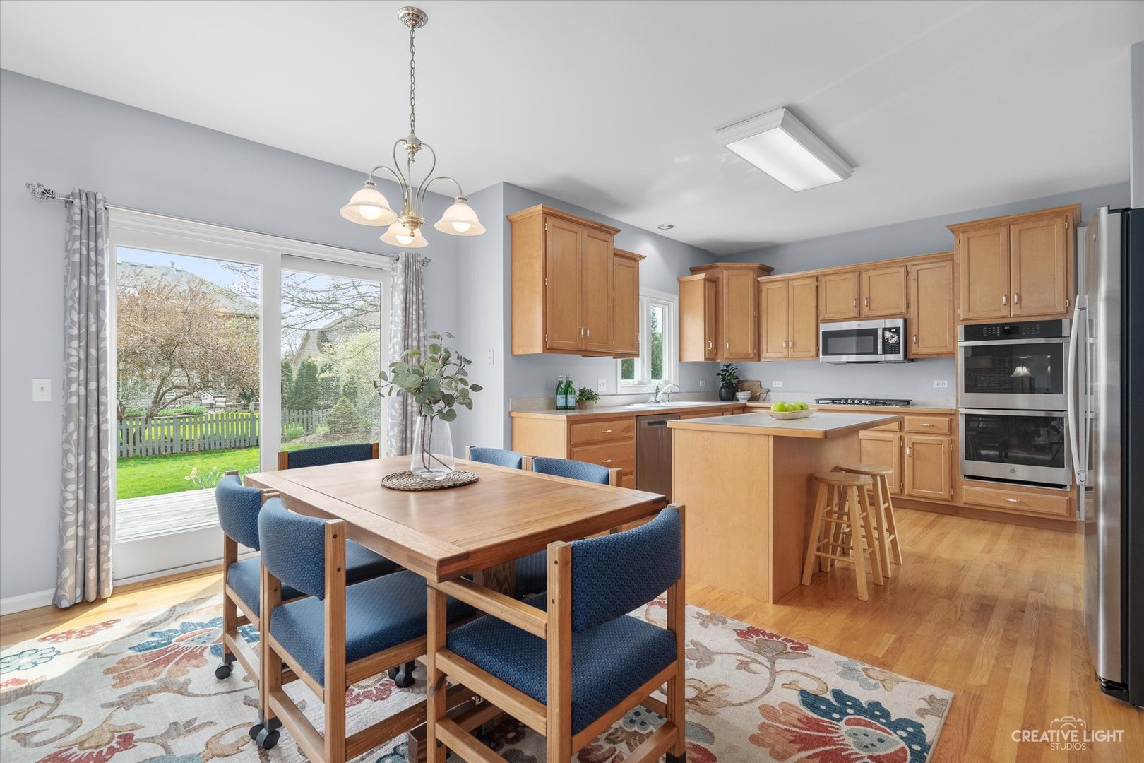 3812 Grassmere Road Naperville, IL 60564 - Photo 6 of 46 a kitchen with kitchen island a dining table and chairs