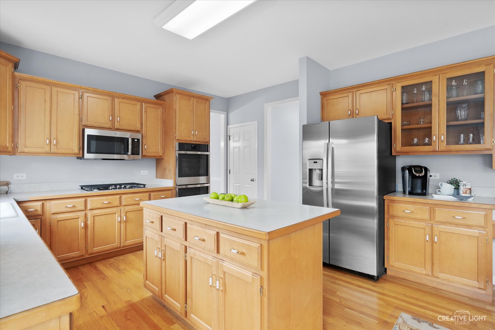 3812 Grassmere Road Naperville, IL 60564 - Photo 7 of 46 a kitchen with stainless steel appliances granite countertop a refrigerator sink stove microwave and cabinets