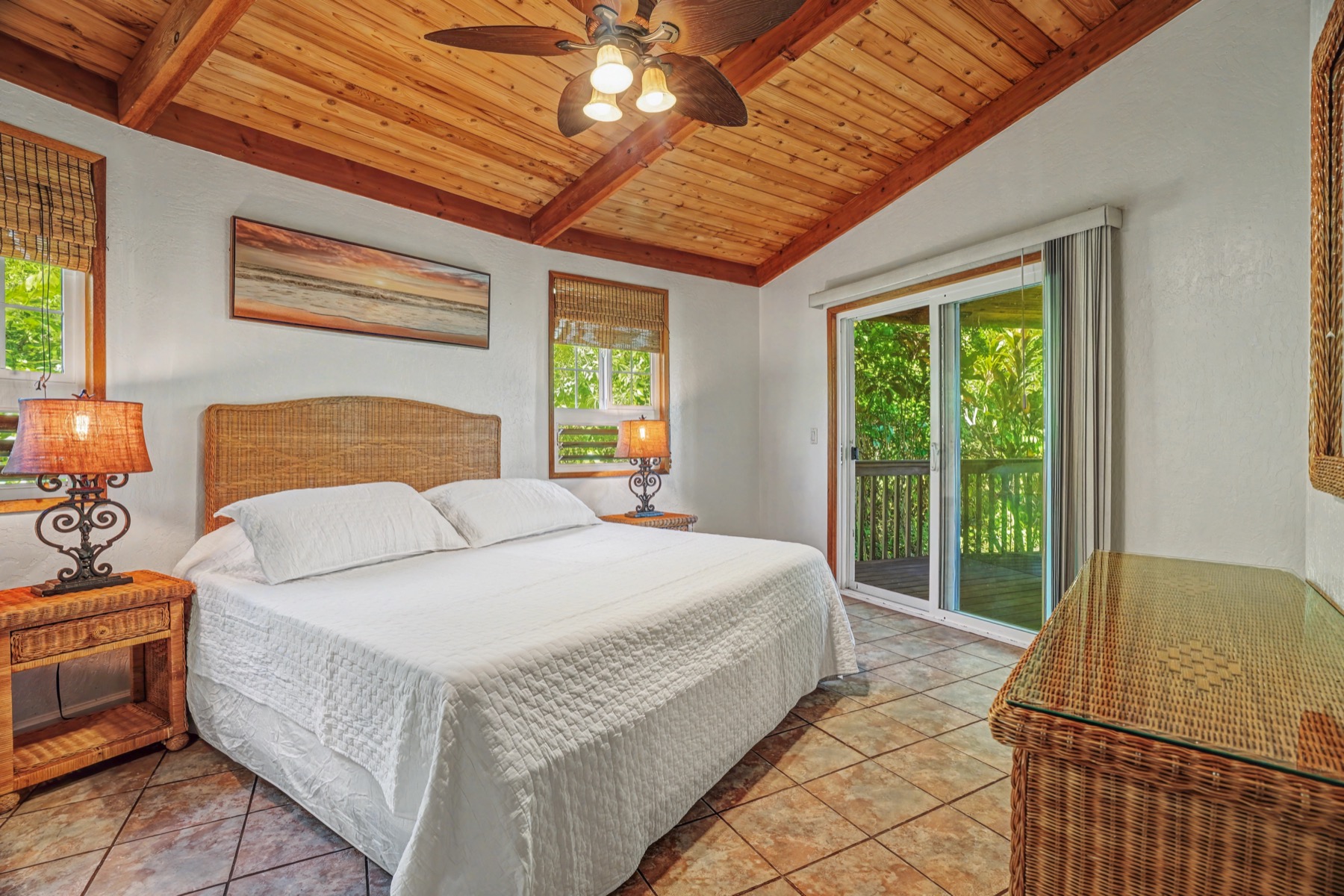 5715 Kaehulua Road, Unit 1 Kapaa, HI 96746 - Photo 16 of 23 a bed sitting in a bedroom next to a window